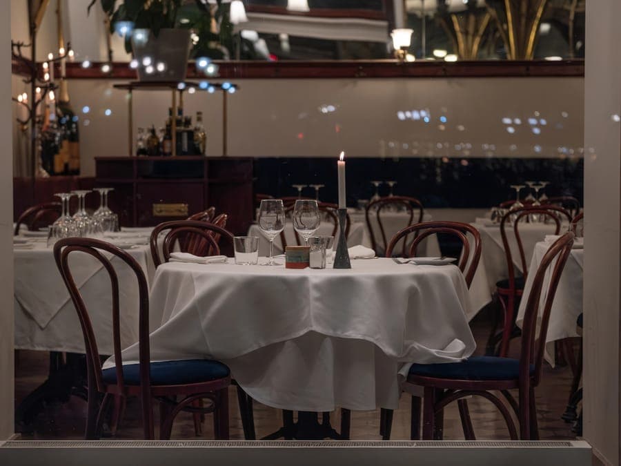 A restaurant dining room set for the evening